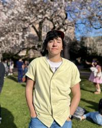 Photo of Jude with cherry blossoms on UW quad